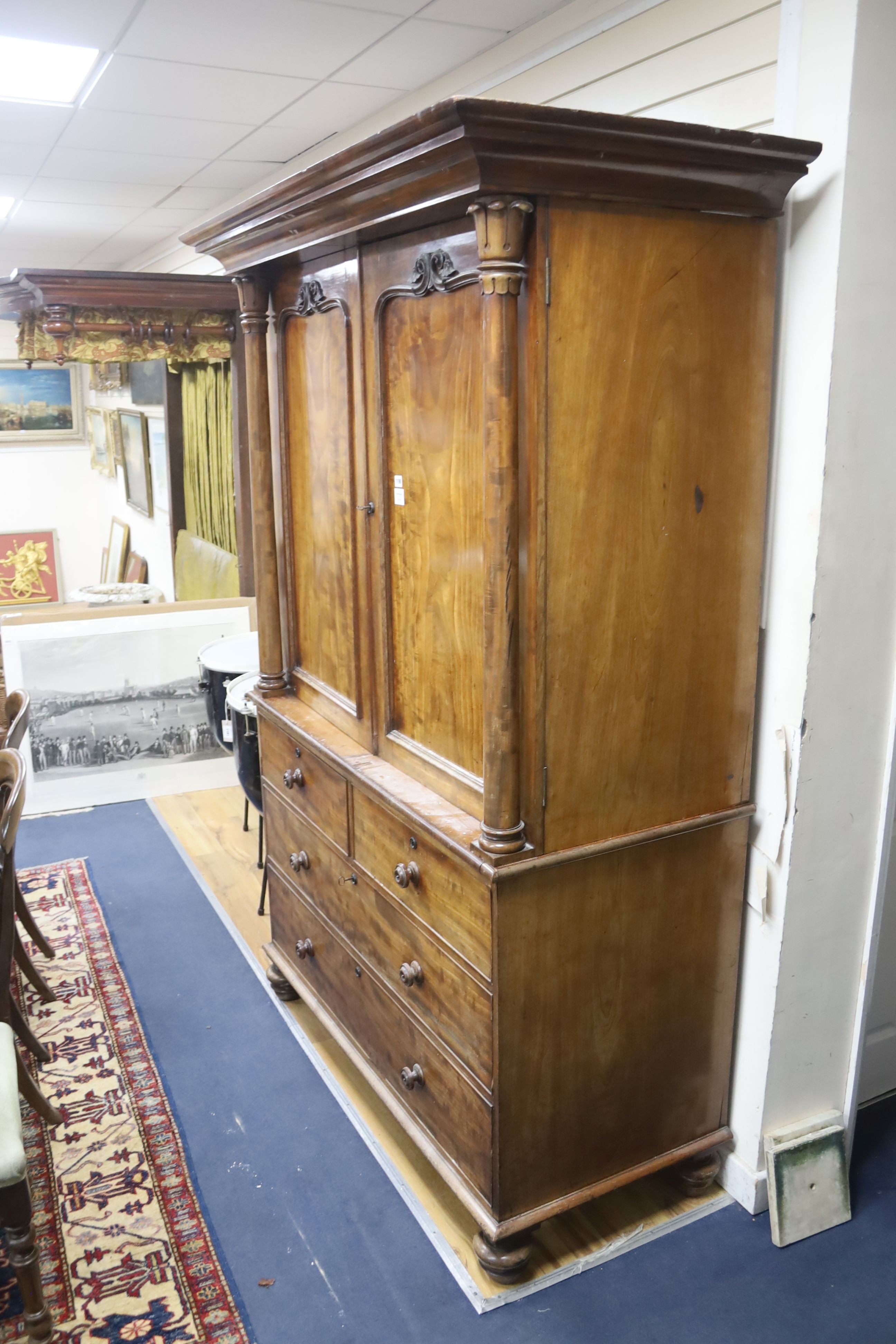 A William IV mahogany linen press, raised over two short and two long drawers, width 132cm, depth 60cm, height 213cm